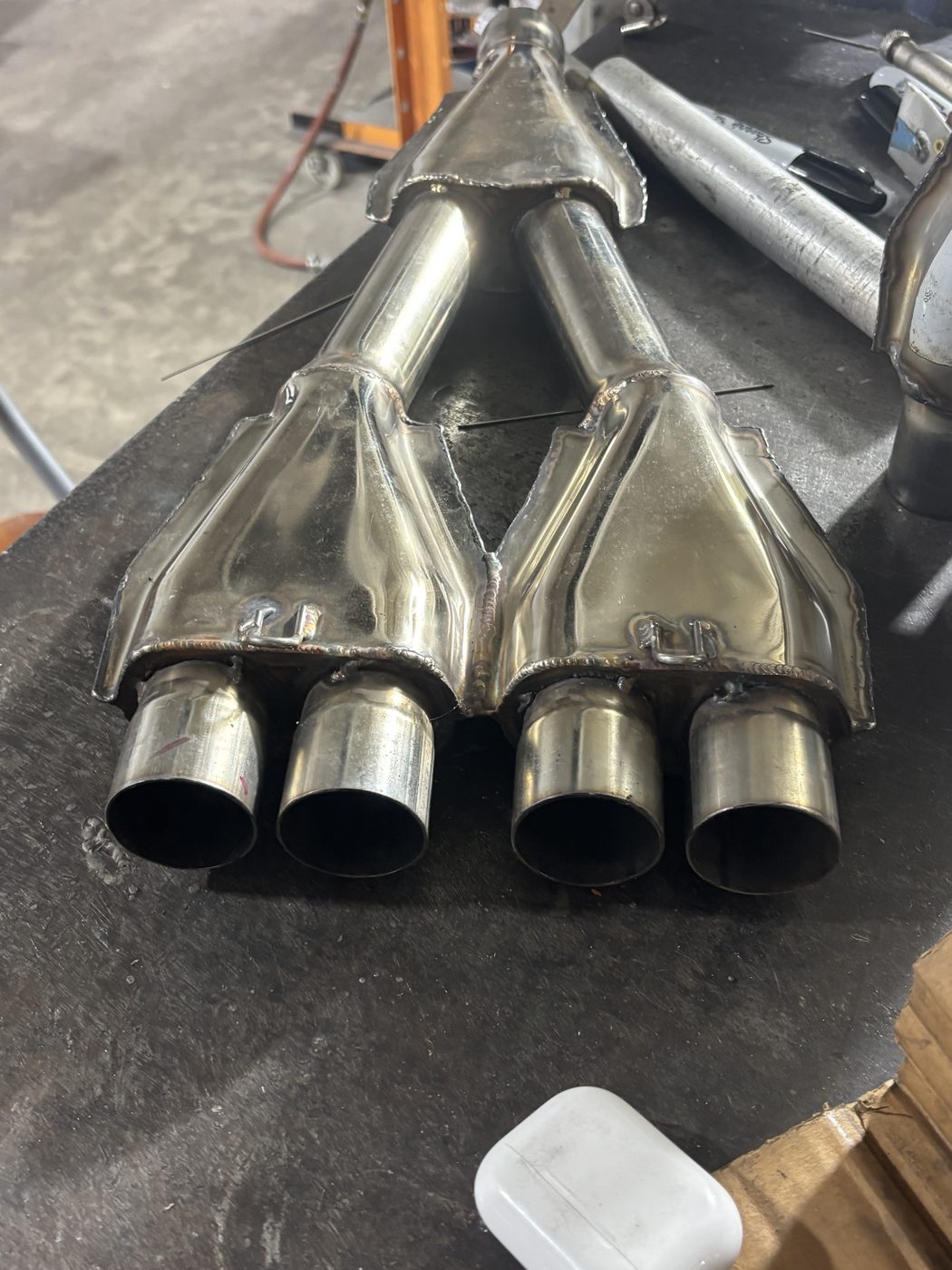 A pair of stainless merge collectors on the bench