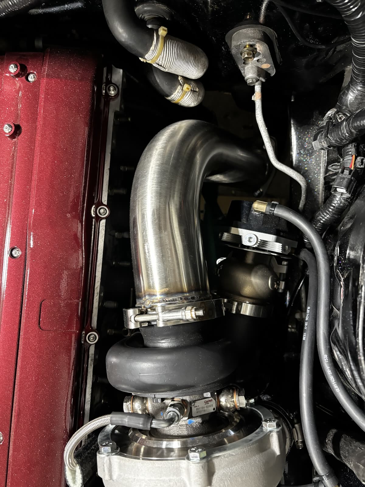 Stainless turbo downpipe on a Nissan Laurel, V-band clamped to a Garrett turbo